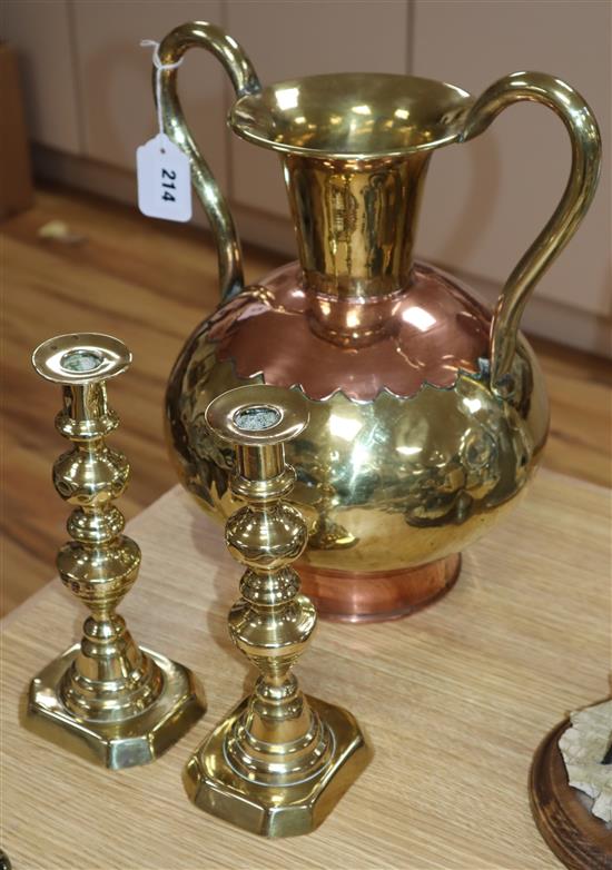 A large brass urn, height 32.5cm and a pair of brass candlesticks